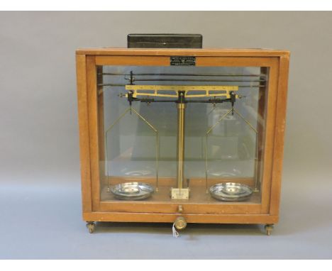 A set of laboratory scales, by Griffin & Tatlock, with a box of weights, 39cm high