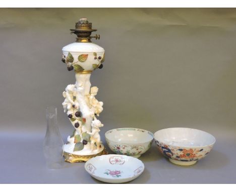 A 'Moore' pottery cherub oil lamp, two Chinese bowls, and a famille rose dish, all damaged