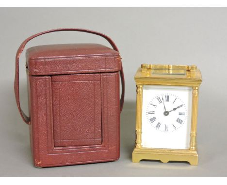 A small brass carriage clock, in a red leather carrying case, 12cm to handle