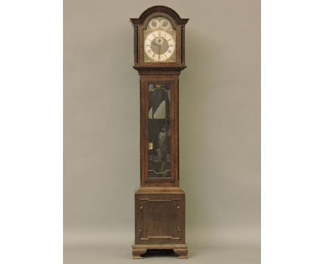 A 1920s oak longcase clock, the brass dial with strike/silent and Westminster, Whittington and Winchester dials in the arch, 