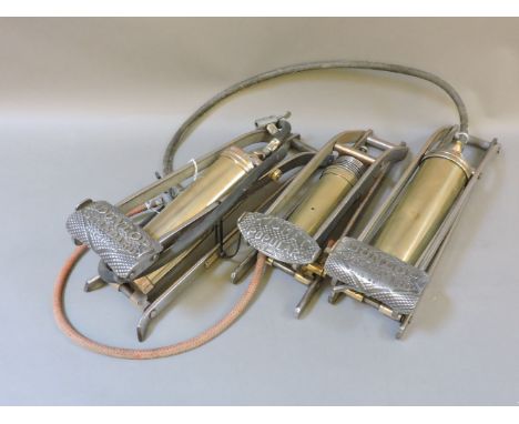 Three brass and steel foot pumps, two Dunlop Standard, and one Kismet Popular