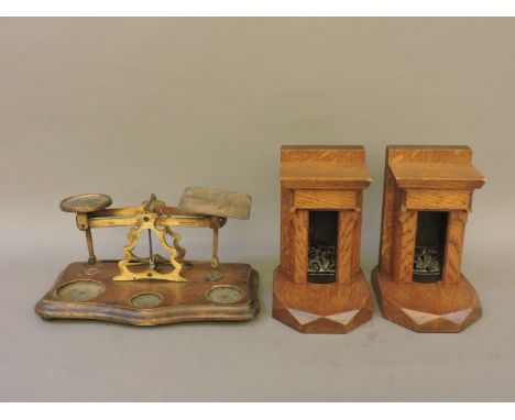 A pair of miniature oak toy chimney pieces, 18cm high, and a set of postal scales
