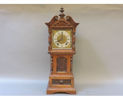 A German 'Ting Tang' miniature longcase clock, with carved oak case, by Lenzkirch, the eight day movement striking the hours 