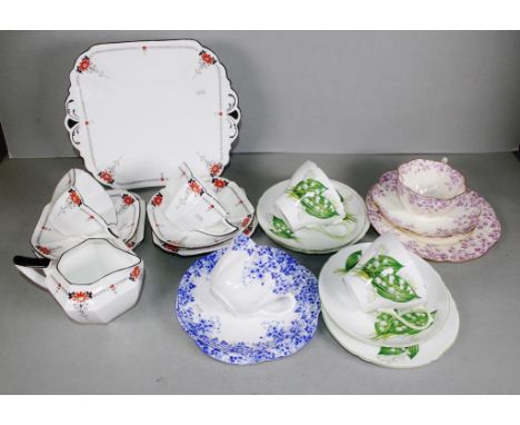 Six various Shelley trios, jug &amp; cake plate to include 2 Lily of the valley trios, 2 Queen Anne red daisy trios, jug and 