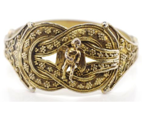 Gilt metal Knot of Hercules bangle Hellenistic revival bangle with applied putto, beads and strip wire. With a riveted joint.
