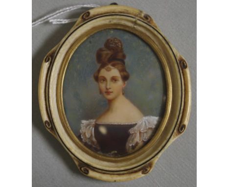 Good antique portrait miniature in a craved ivory frame. A austere lady, with high hair and a low cut dress, painted on ivory