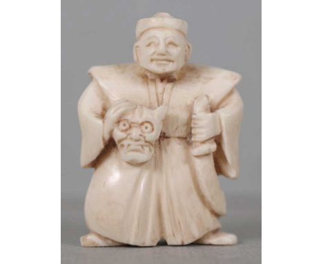 Antique Japanese carved ivory netsuke depicting a man holding a sword, signed to base, 5cm high approx. This item may not be 