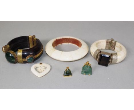 Two various stone set Chinese bangles 1 stone set on bone, the other stone set on wood; together with a bone bangle; and 2 va