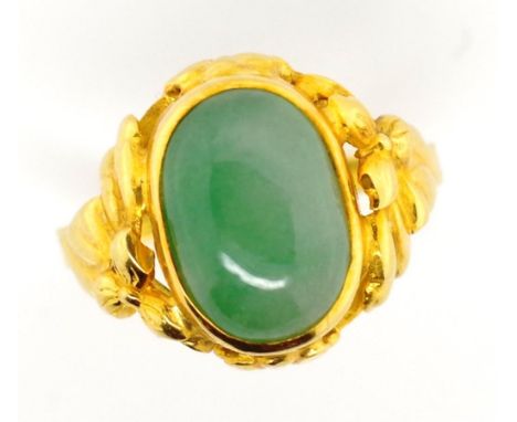 18ct gold and jade ring approx 11.1mm x 7.8mm oval cut jade cabochon set in a rub over setting with flower decorated shoulder