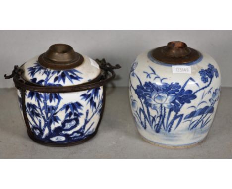 Two Vietnamese ceramic water pipes each with brass fitting to top, decorated with blue and white figures, character marks to 