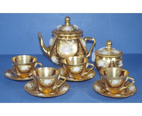 Vintage ten piece Bohemian Czech glass teaset in ruby glass with ornate gilt &amp; in relief floral decoration, comprising of