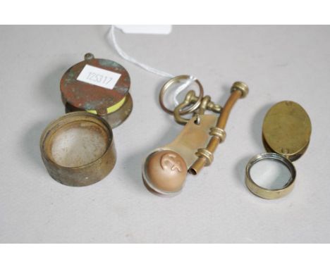Two various vintage brass retractable eyeglasses together with a brass boatswains whistle.