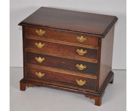 George III style miniature chest of drawers, with four drawers, brass drop handles &amp; raised on bracket feet, 24.5cm wide 