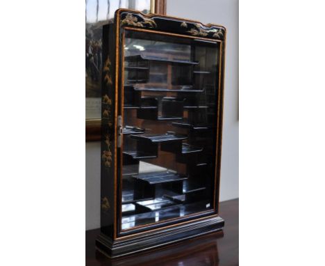 Chinese lacquered wall display cabinet decorated lacquer to door edges and sides, glass door opening to lacquered, segmented,