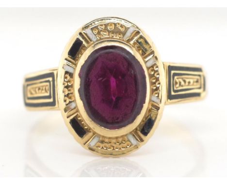 Antique gold, enamel and garnet ring unmarked approx 2.85 grams, ring size N. * Showing some loss to enamel.