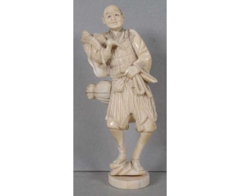 Antique Japanese Meiji period carved ivory okimono depicting a man holding a bird and rope, losses to rope section, signed to