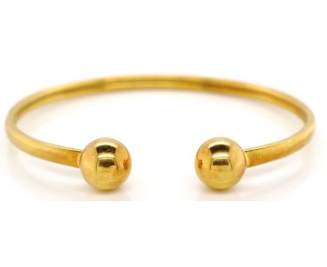 18ct yellow gold bangle with ball ends, marked K18 approx 11.8 grams and 60mm inside width