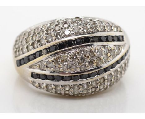 18ct gold, black and white diamond ring marked 750 approx diamond total weight 0.65ct. Total ring weight, ring size O.