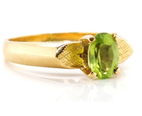 Gold and peridot ring unmarked gold approx 3.8 grams, ring size L. Tests as 14ct