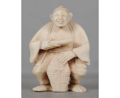 Antique Japanese carved ivory netsuke depicting a man holding a sake barrel, 5cm high approx. This item may not be exported w