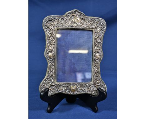 An Art Nouveau silver clad easel photograph frame J &amp; R Griffin, Chester 1906, having all-over sinuous and c-scroll decor