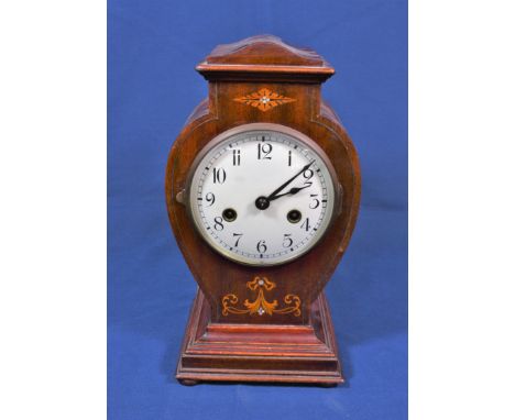 An Edwardian inlaid mahogany mantel clock the ivory enamel Roman dial within a vase shaped case with inlaid floral and foliat
