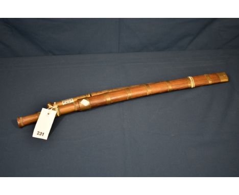 A 19th century Burmese Dha with 21in. (53.3cm.) slightly curved edge square ended blade, engraved with flower heads to end, t