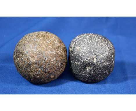 Two cannon balls - round shot - one in stone, the other iron, the largest, 3 1/4in. (8.2cm.). 