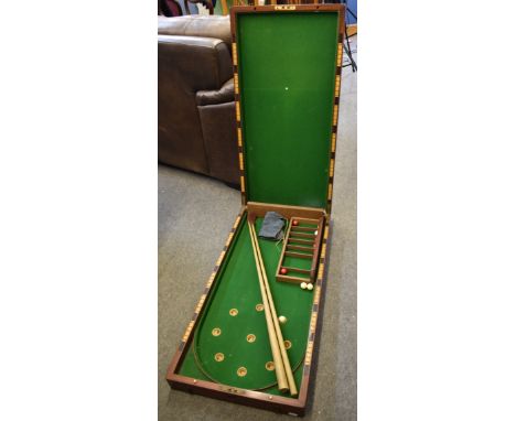 A late Victorian mahogany folding bagatelle board and accessories the interior with green baize, numbered cups and scoring to