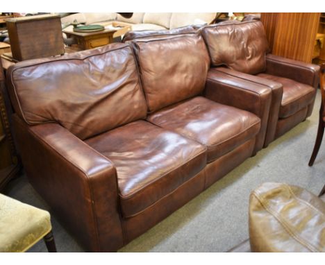 A brown leather two seater sofa with matching club chair (2) 