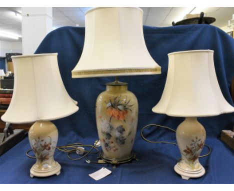 A large ceramic table lamp with hydrangea/raspberry/butterfly decoration together with a pair of ceramic baluster table lamps