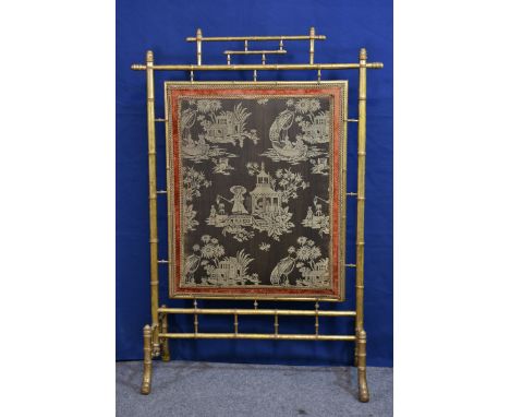 A large 19th century giltwood simulated bamboo firescreen in the George III manner with gold pleated silk to back and padded 