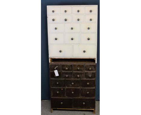 A pair of vintage shop storage drawers, sixteen graduated drawers in each, one painted white (2) 