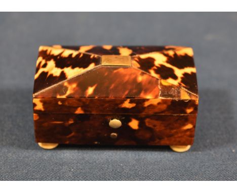 A Regency tortoiseshell novelty needle case in the form of a sarcophagus shaped tea caddy, with turned bone feet, inscribed '