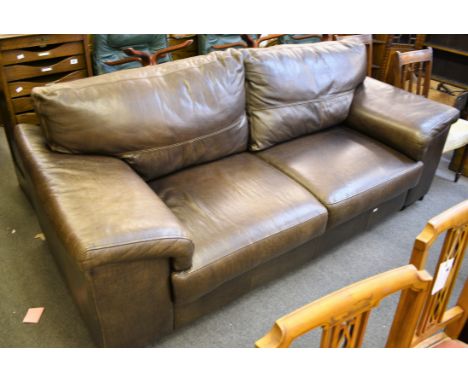 A modern brown leather three seater sofa. 