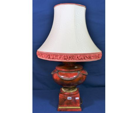 A Thomas Blakemore Limited urn shaped lamp, red and gilt with swag decoration, stitting on square base. 