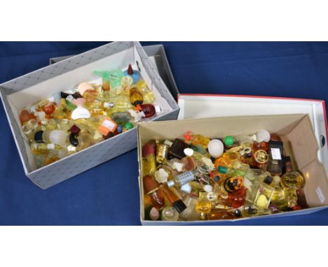 A large collection of various miniature perfume bottles to include Christian Lacroix, Christian Dior, Clarins and Elizabeth A