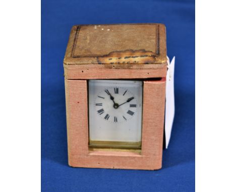 A French brass carriage timepiece with corniche case, white enamel Roman dial, single train movement, 4 1/4in. (10.8cm.) high