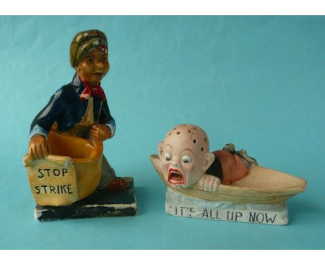 A composition figure of a newspaper boy holding a ’Stop Strike’ placard, circa 1926, 141mm and a bisque porcelain hat pin sta