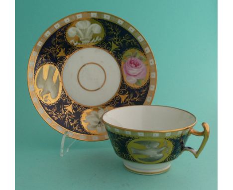 George, Prince of Wales: an English porcelain cup and saucer painted in colours upon gilt oval panels on a cobalt blue and gi