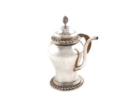 A George III silver argyle,by William Grundy, London 1771,baluster form, wicker-bound scroll handle, the body with a hinged c