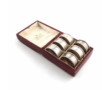 A matched set of six silver napkin rings,maker's mark of R.R, one by William Aitken, Birmingham 1927, retailed by Mappin and 