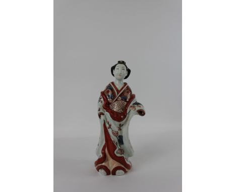 A 20th century ceramic model of a Japanese Geisha, with painted red outline, decorated with flowers and plants throughout, 36