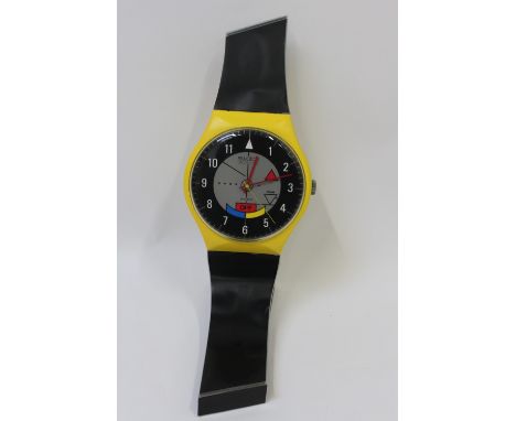 A Swatch oversized advertising watch, on a black stand, 72cm long