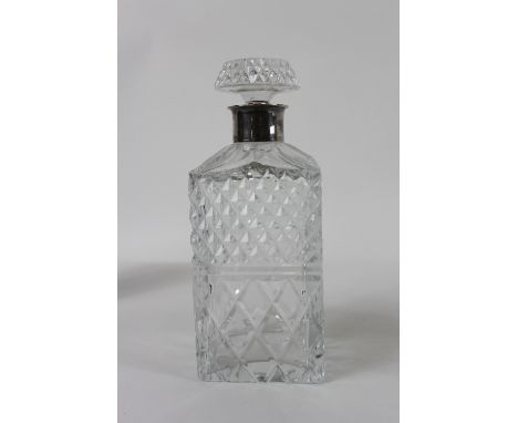 A cut glass decanter with a silver collar, London 1974