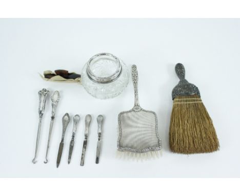 A table brush, stamped 'Sterling'; with a silver backed hair brush; a large glass pot with a silver mounted rim; a button hoo