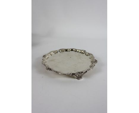A late Victorian silver salver, by Elkington & Co Ltd, London 1894, of circular shaped outline with S scroll and shell border