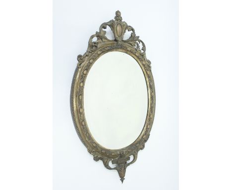 A 19th century wooden gilded mirror, of oval form, with shaped finial and base, 83cm high