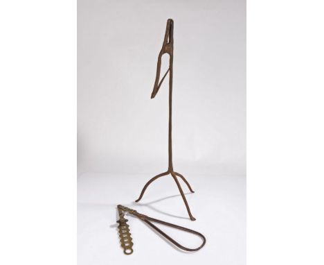 18th Century iron rush light holder, with a sprung action grip above the column and arched legs, 55cm high, together with an 