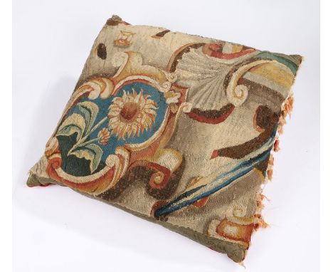 A large cushion of 18th century tapestry, designed with a sunflower within a cartouche, backed with velvet, feather filled,&n